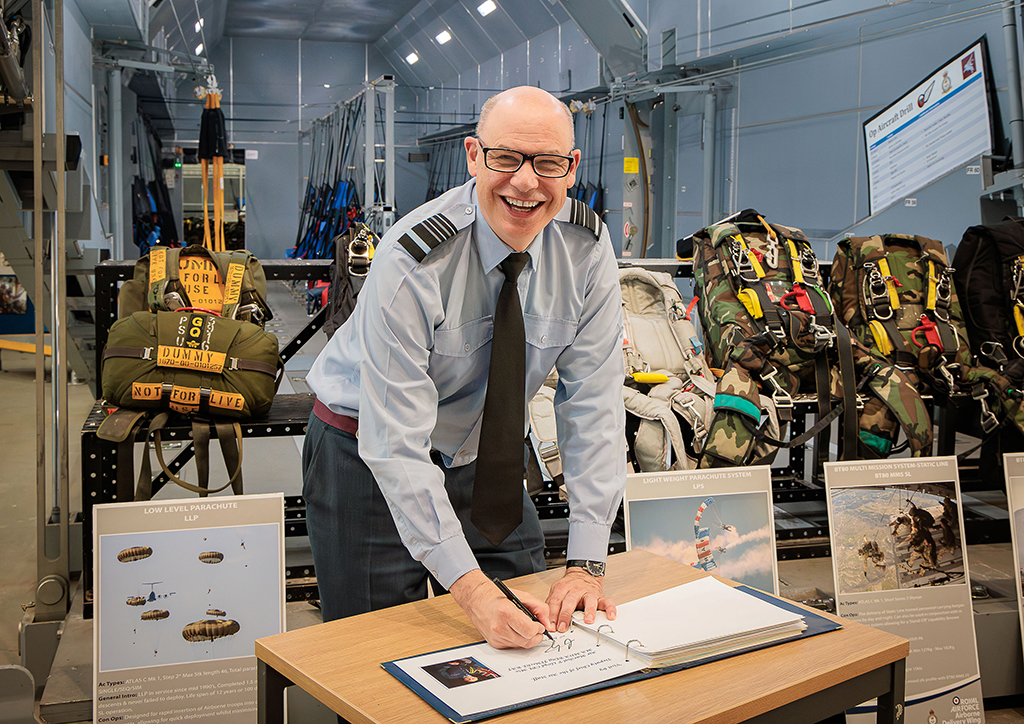 The Deputy Chief of the Air Staff, Air Marshal Paul Lloyd CBE MSc MA MDA BEng CEng FIMechE RAF, signs a visitors book